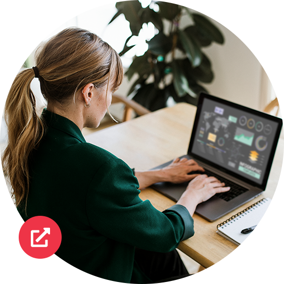 Woman with pony tail typing on a laptop.